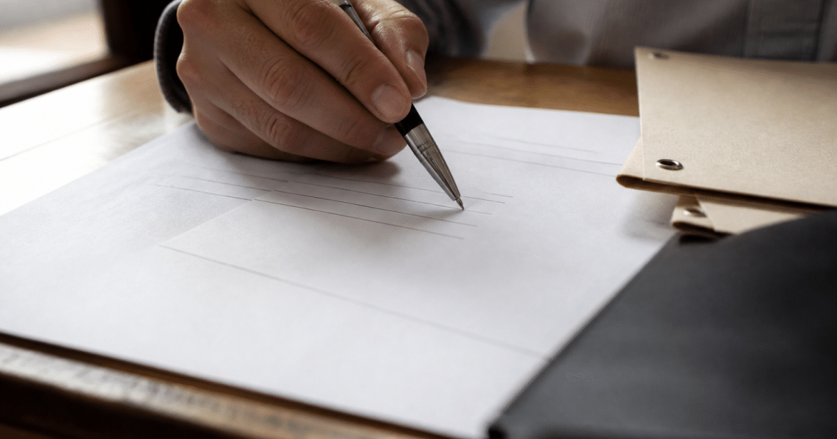Document officiel sur bureau avec stylo pointant vers signature