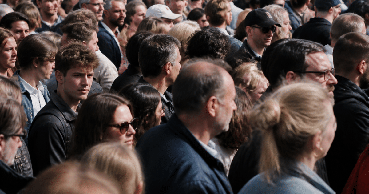 Foule dense de personnes debout serrées ensemble dans rue